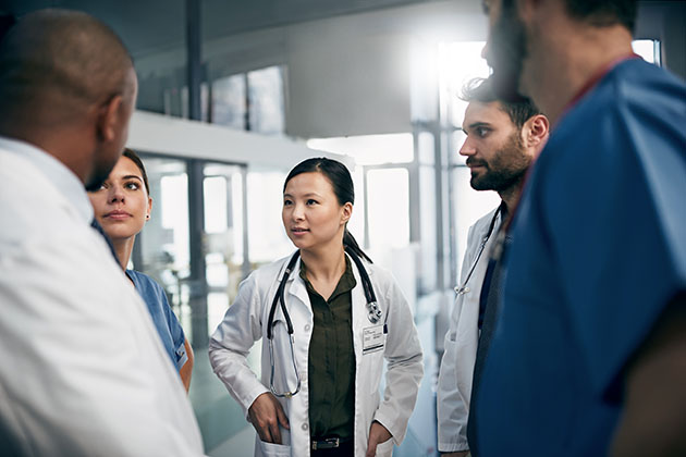stock photo Shot of a diverse team of doctors having a discussion