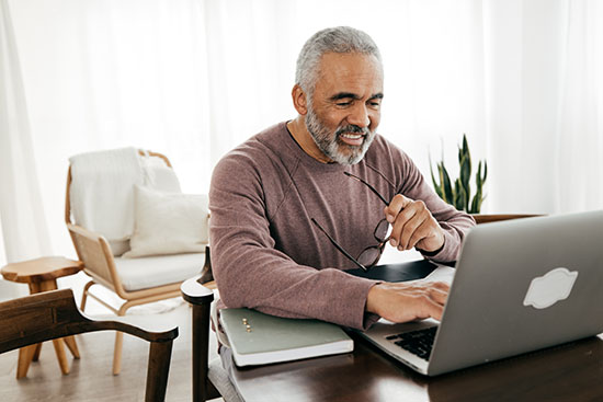 Senior man taking online lesson stock photo