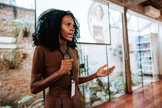 Woman giving speaker presentation - stock photo