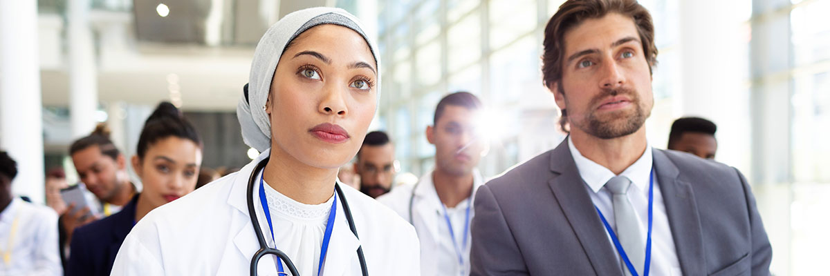 Female doctor with businessman attending seminar