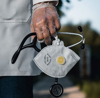 Man holding his N95 Mask outdoor during COVID-19, "Coronavirus" pandemic