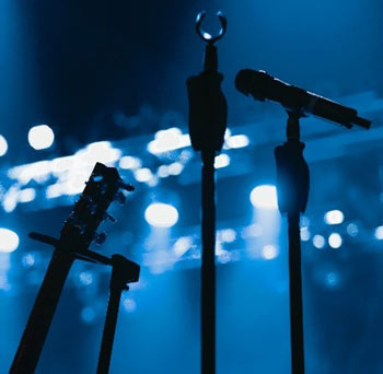 Four microphones in the dark club with spotlights - stock photo