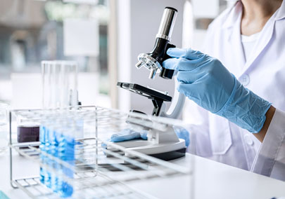 Scientist or medical in lab coat working in biotechnological laboratory, Microscope equipment for research with mixing reagents in glass flask in clinical laboratory.