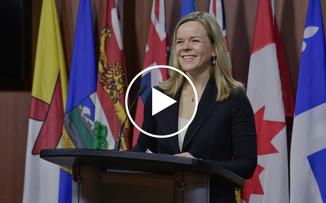Dr. Sarah Cook speaking at a podium